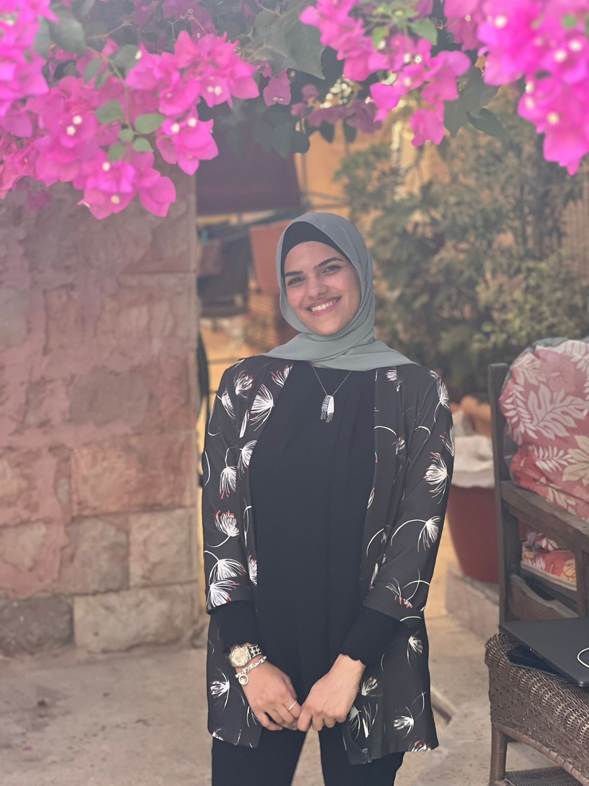 Noor Essam Mohammad, Arabic teacher at Aiwa Amiya, smiling in Amman