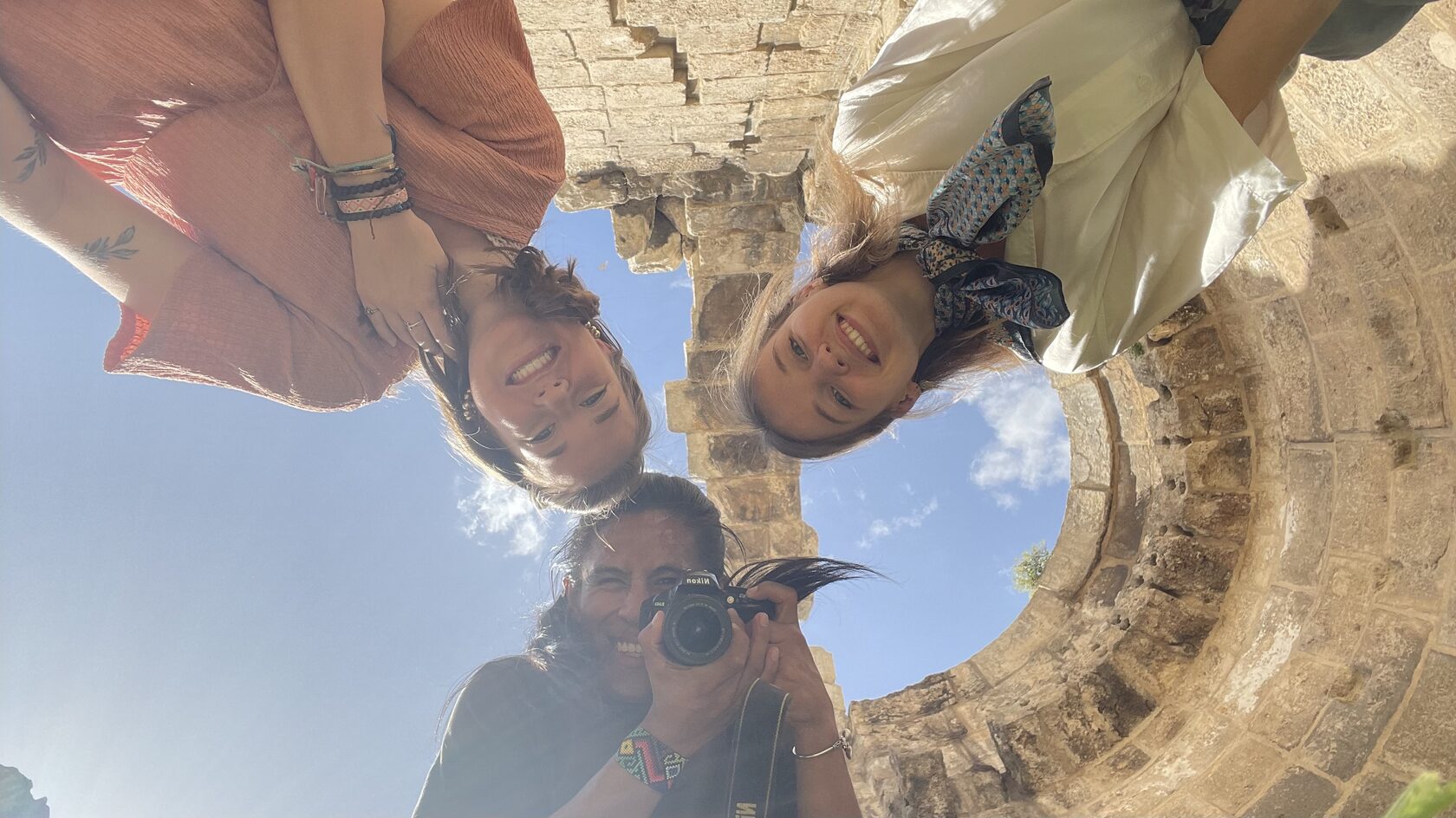 Group of friends taking a selfie at an ancient site in Jordan